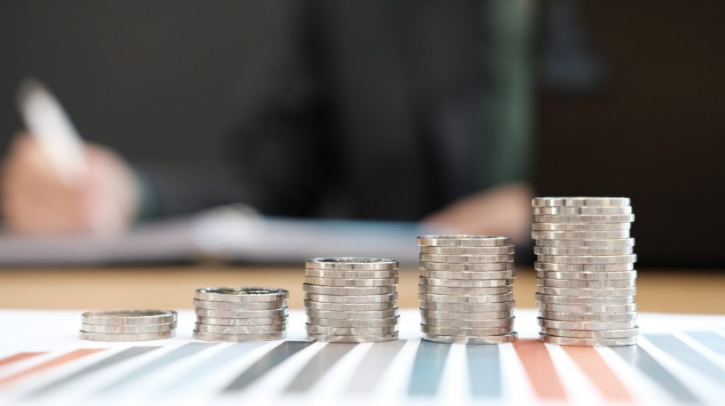 progressively taller stacks of coins on a colorful placemat